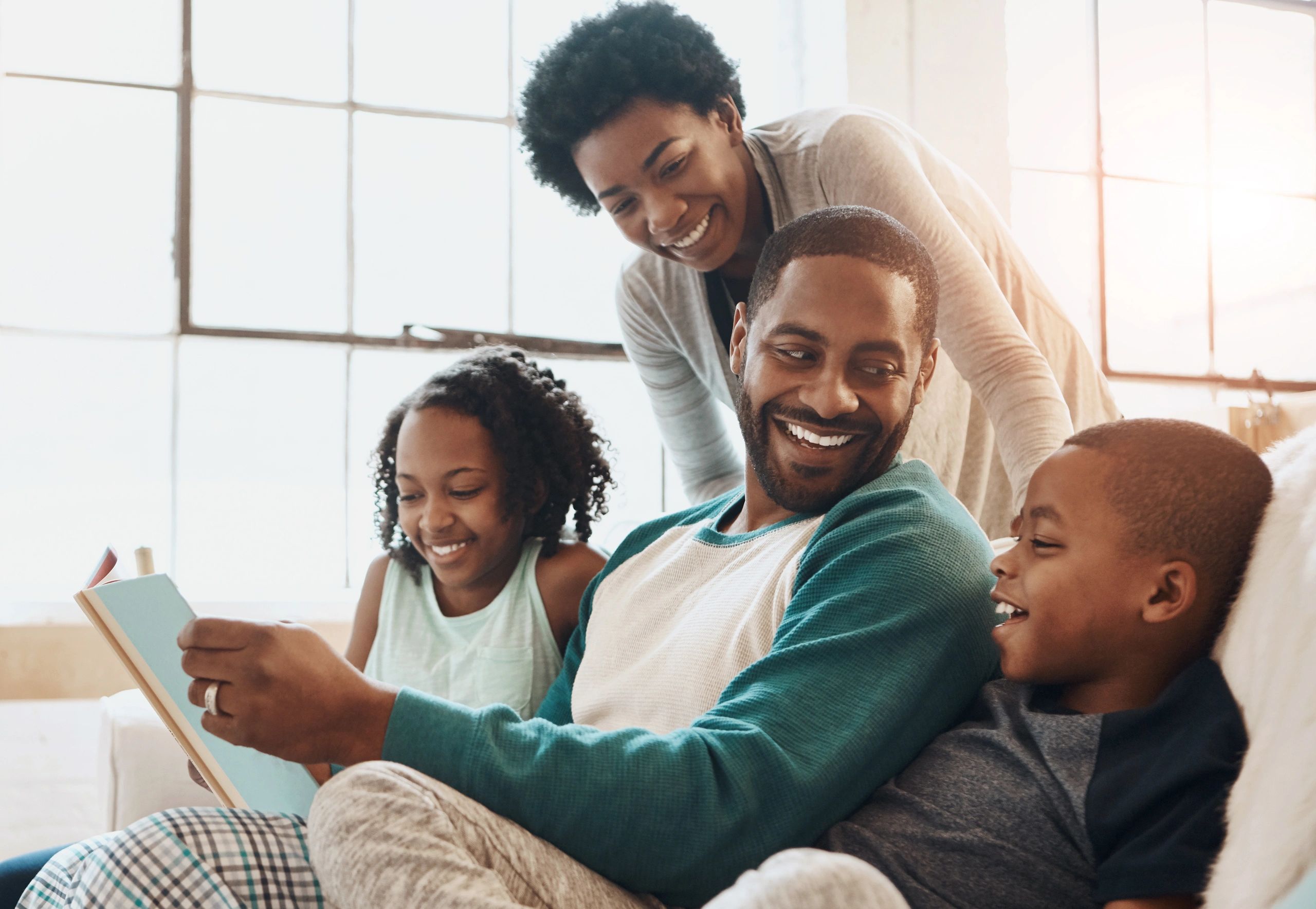 happy Black family reading children's books together